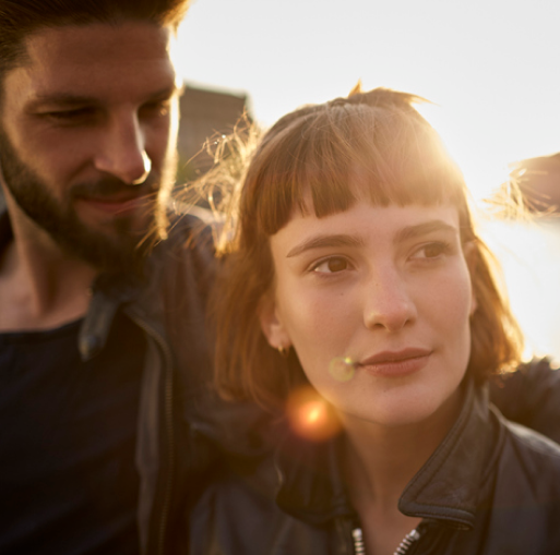 Man with his arm around a woman's shoulder 